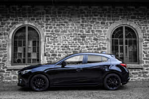 A Stylish Mazda 3 Hatchback In Spectacular Movement Wallpaper