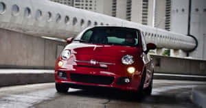 A Stylish White Fiat 500 On The Road Wallpaper