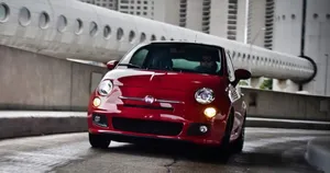 A Stylish White Fiat 500 On The Road Wallpaper