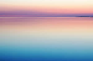 A Sunset Over A Calm Body Of Water Wallpaper