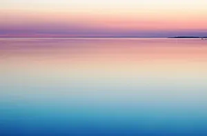 A Sunset Over A Calm Body Of Water Wallpaper