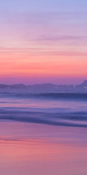 A Sunset With A Pink Sky And Water Wallpaper