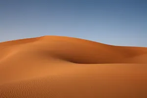 A Surreal Desert Landscape During The Day Wallpaper