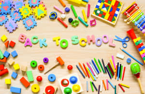 A Table With Toys And Letters On It Wallpaper