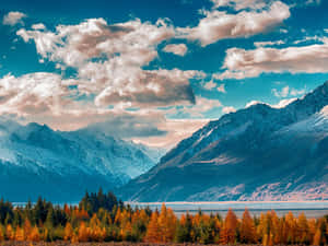 A Tranquil View Of A Sun Slowly Setting Over A Calm Beach On A Clear Day. Wallpaper