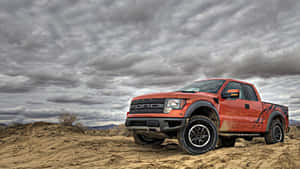 A Truck Is Driving On A Dirt Road Wallpaper