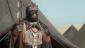 A Tusken Raider Surveys The Arid Desert Wallpaper