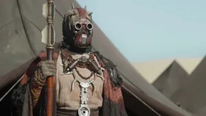 A Tusken Raider Surveys The Arid Desert Wallpaper