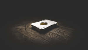 A Variety Of Playing Cards Spread On A Wooden Table Wallpaper