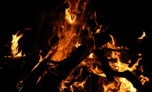 A Vibrant And Lively Beach Bonfire At Sunset Wallpaper