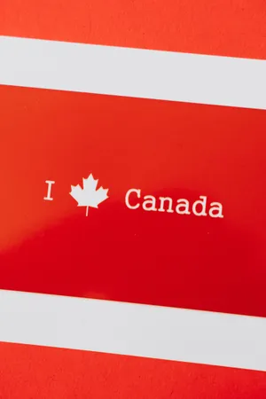 A Vibrant Canadian Maple Leaf Symbolizing Canada's Rich Heritage Wallpaper