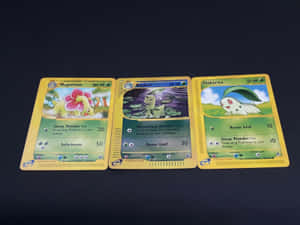 A Vibrant Depiction Of Meganium, Bayleef, And Chikorita In Pokémon Trading Cards Wallpaper