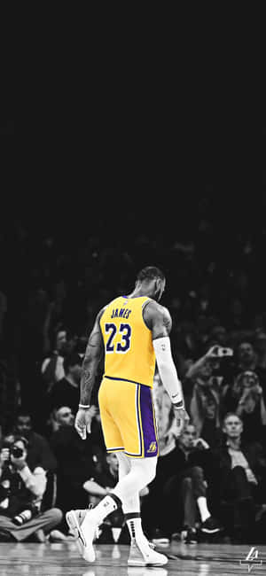 A Vibrant Image Of Lebron James Using His Iphone. Wallpaper