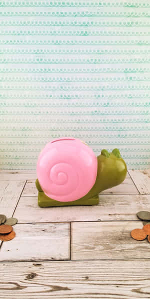 A Vibrant Pink Snail Amidst Lush Greenery Wallpaper