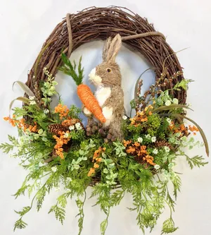 A Vibrant Spring Wreath Adorned With Colorful Flowers And Foliage Wallpaper