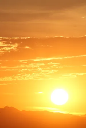 A Vibrant Yellow Sky At Sunset Wallpaper