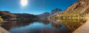 A View Of A Lake With Mountains In The Background Wallpaper