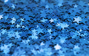 A View Of A Night Sky Filled With Bright Blue Stars Wallpaper