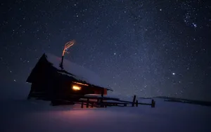 A View Of A Night Sky With Stars Sparkling In The Darkness Wallpaper
