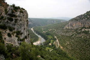 A View Of A River And Mountains In A Valley Wallpaper