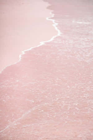 A View Of A Stunning Pink Sunset Beach. Wallpaper