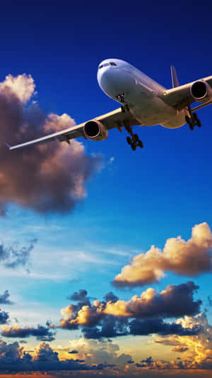 A View Of The City Skyline And A Person Using A Phone While On A Plane Wallpaper