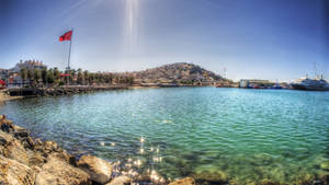 A View Of The Water And A Boat In The Background Wallpaper