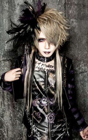 A Visual Kei Band Performing On Stage In An Atmospheric Concert Wallpaper