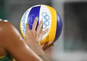 A Volleyball Player Enjoys A Match On Their Laptop Wallpaper