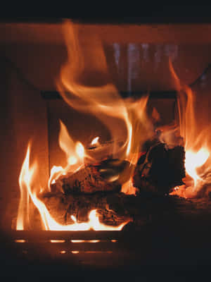 A Warm And Inviting Fireplace Scene Wallpaper