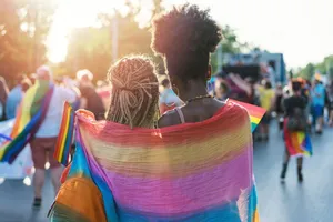 A Warm, Inspiring Image Of A Lesbian Couple Under A Cute Lgbt Flag. Wallpaper