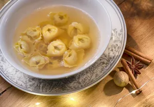 A Warm Serving Of Traditional Tortellini In Brodo With Cinnamon Rolls Wallpaper