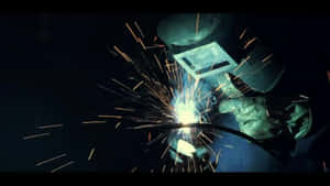 A Welder Is Welding With Sparks In His Face Wallpaper