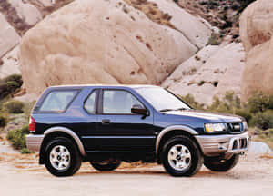 A Well-maintained Classic Isuzu Amigo Parked In An Open Field Wallpaper