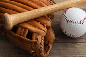 A Well-worn Baseball Glove Placed On The Field Wallpaper