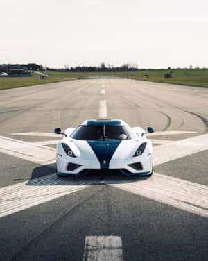 A White And Blue Sports Car On A Runway Wallpaper