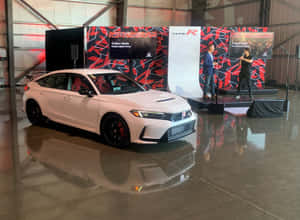 A White Car Is On Display In A Showroom Wallpaper