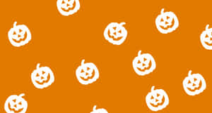 A White Pattern Of Pumpkins On An Orange Background Wallpaper