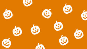 A White Pumpkin Pattern On An Orange Background Wallpaper