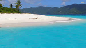 A White Sand Beach With Blue Water Wallpaper