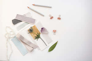 A White Table With Various Items On It Wallpaper