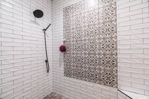 A White Tiled Shower With A Black And White Tiled Wall Wallpaper