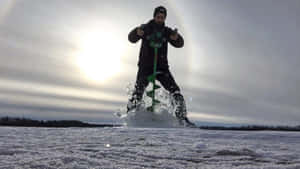 A Winter Adventure Awaits: Ice Fishing At Sunrise Wallpaper