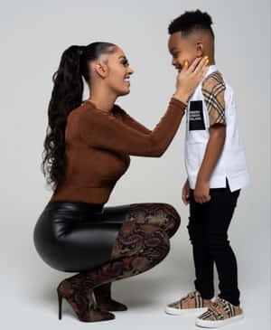 A Woman And A Child Are Posing For A Photo Wallpaper