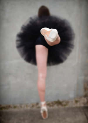 A Woman In A Black Tutu Is Posing Wallpaper