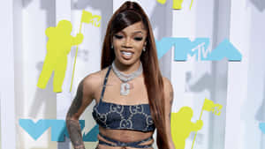 A Woman In A Blue Outfit With Tattoos On Her Back Wallpaper