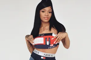 A Woman In A Bra Top And Jeans Posing Wallpaper