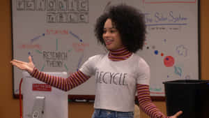 A Woman In A Green Shirt Standing In Front Of A Whiteboard Wallpaper