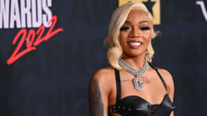 A Woman In A Leather Dress And A Black Bra Wallpaper