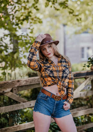 A Woman In A Plaid Shirt And Denim Shorts Posing Wallpaper